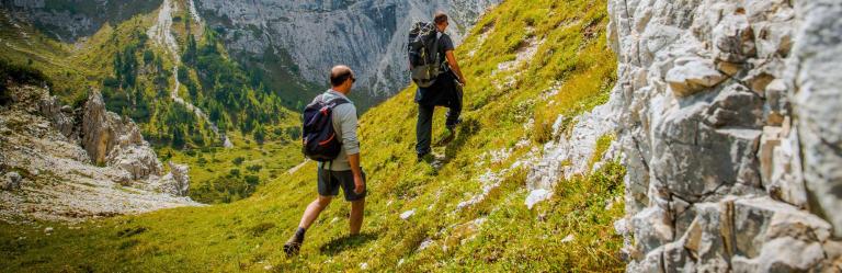 walkers on mountain side path in northern italy