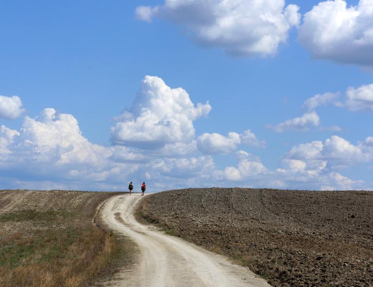 women walking via francigena siena buonconvento