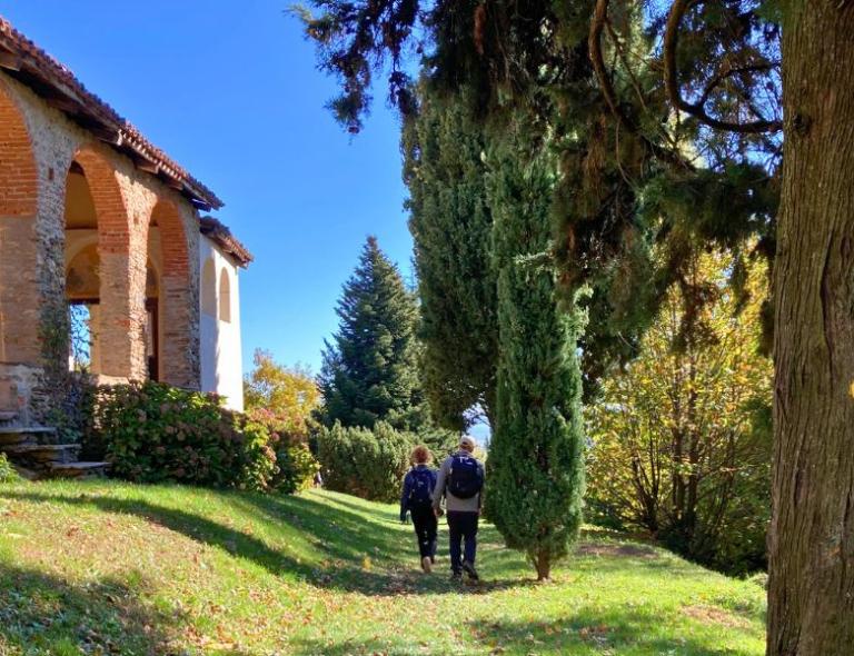 woman walking in the woods of camino de oropa