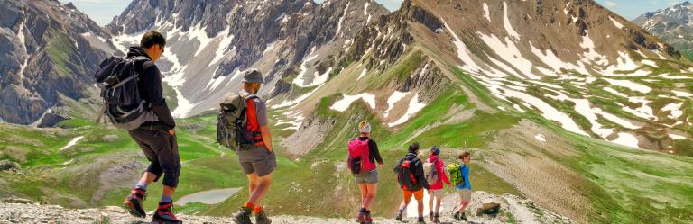 small group descending alpine path