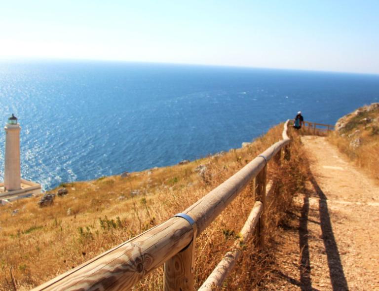 walking trail in Puglia in Italy with ligthouse of Punta Palascia