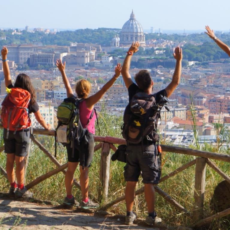 Pilgrims reaching Rome along the Via Francigena Viterbo to Rome with a view of St. Peter’s Dome