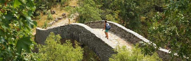 via francigena woman crossing the cisa pontremoli bridge