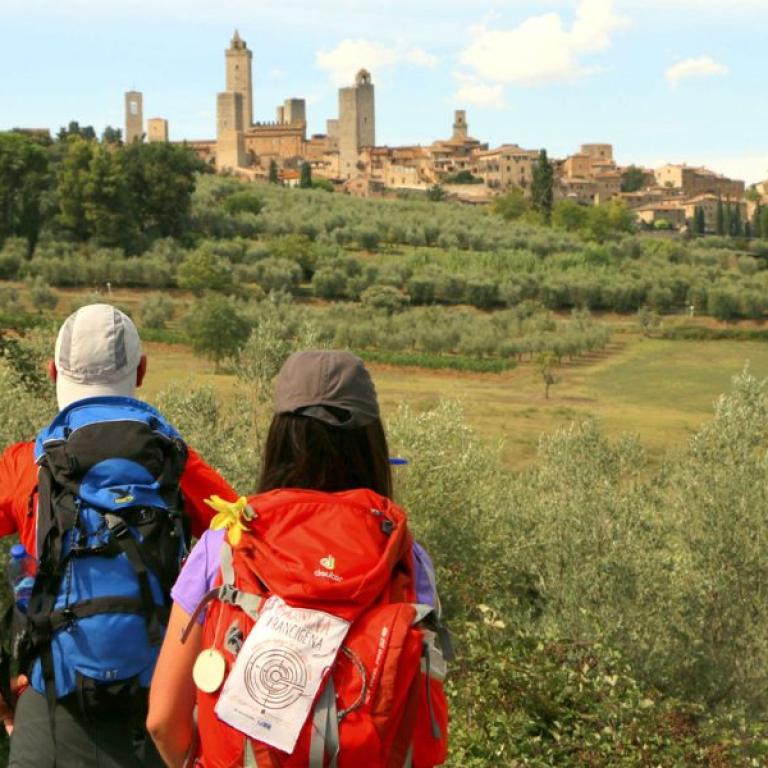 via francigena admiring san gimginano skyline and its medieval towers