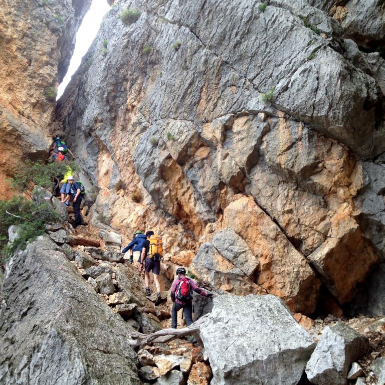 hikers sardinia ascent rocks