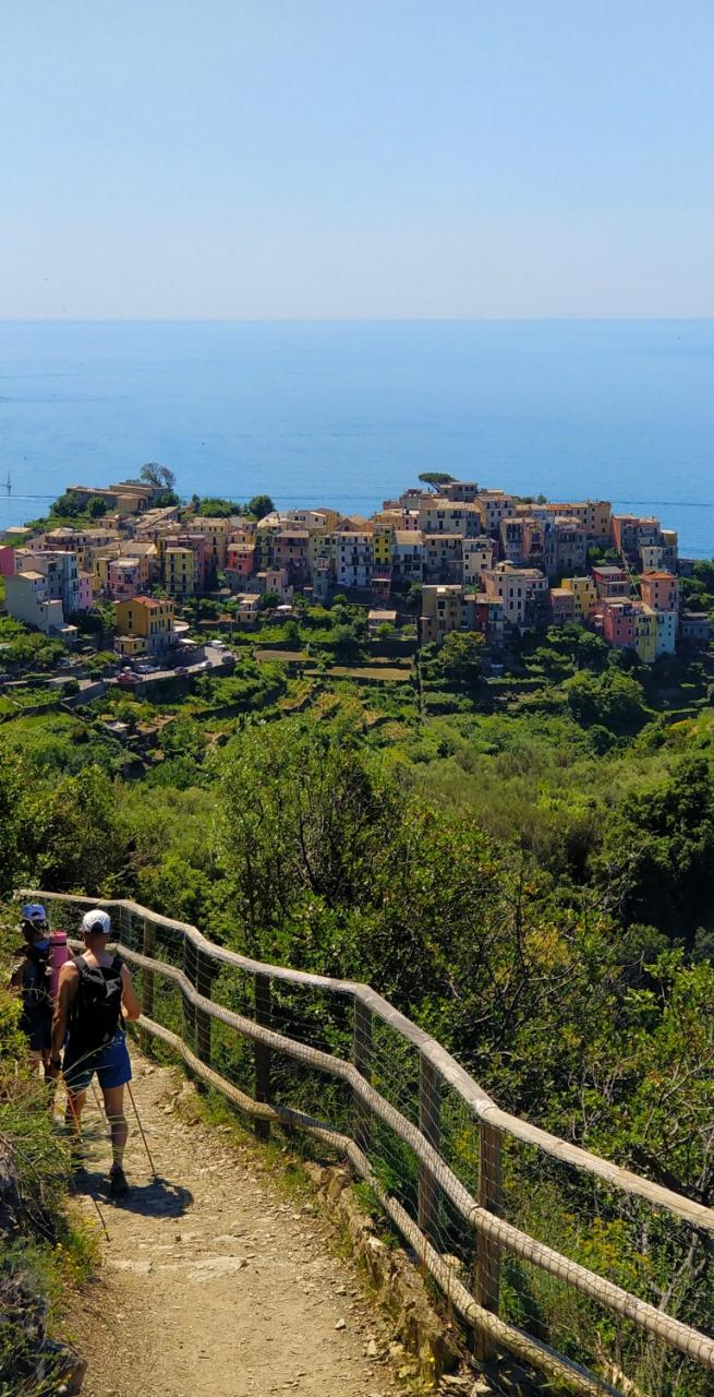 hikers relaxing at Cinque Terre with view of Punta Mesco