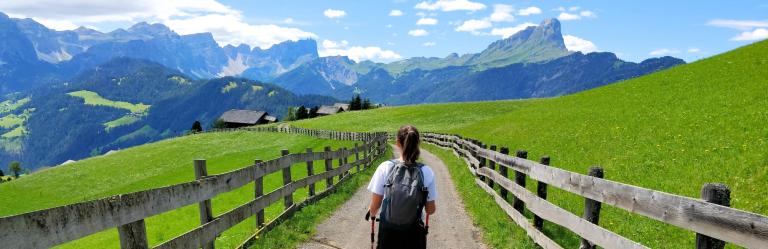 Dolomites Val Badia blue sky above the green meadow