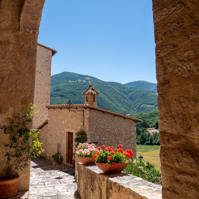 Stone village along the St Francis Way with views of the Umbrian hills
