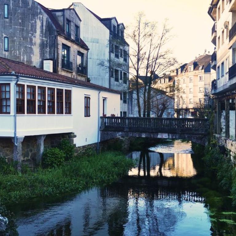 Puente Sampayo on the Camino Portuguese with houses in background