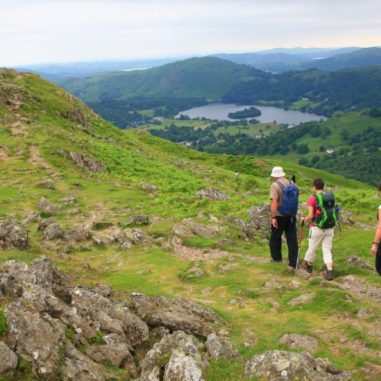 people walking coast to coast downhill to the lake