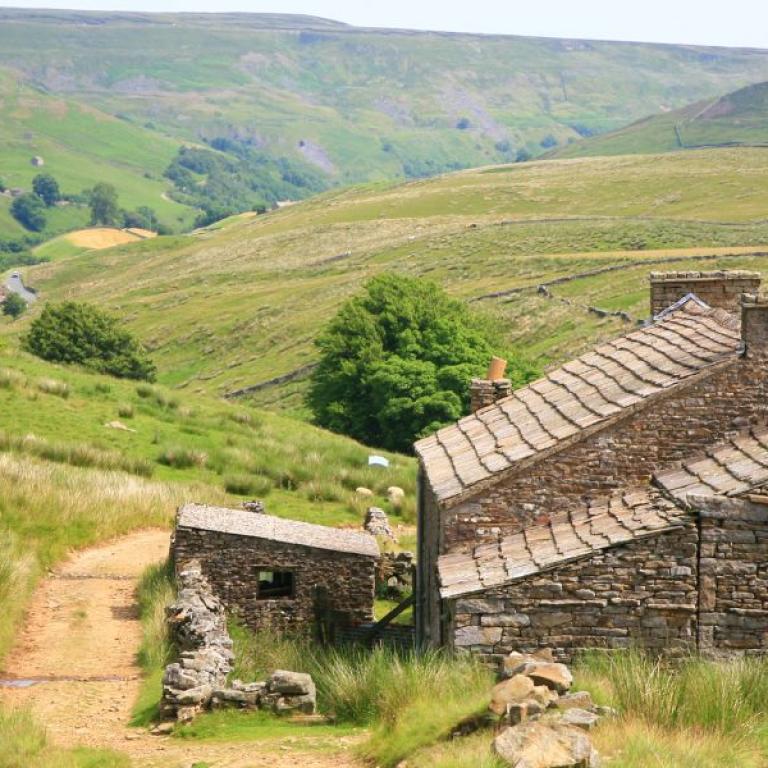 walking coast to coast landscape and an old house