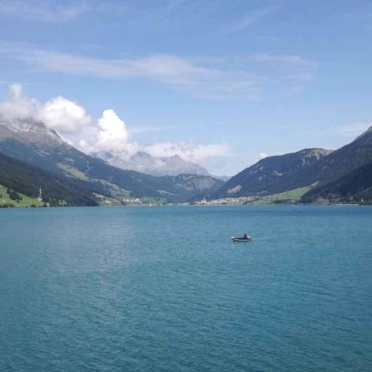 landscape of lake resia and its mountains in val venosta