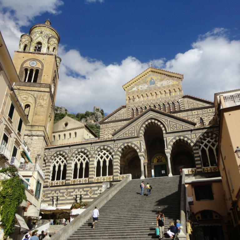 The ornate Amalfi Cathedral rising above the square, a must-see stop on many Amalfi Coast walking routes.