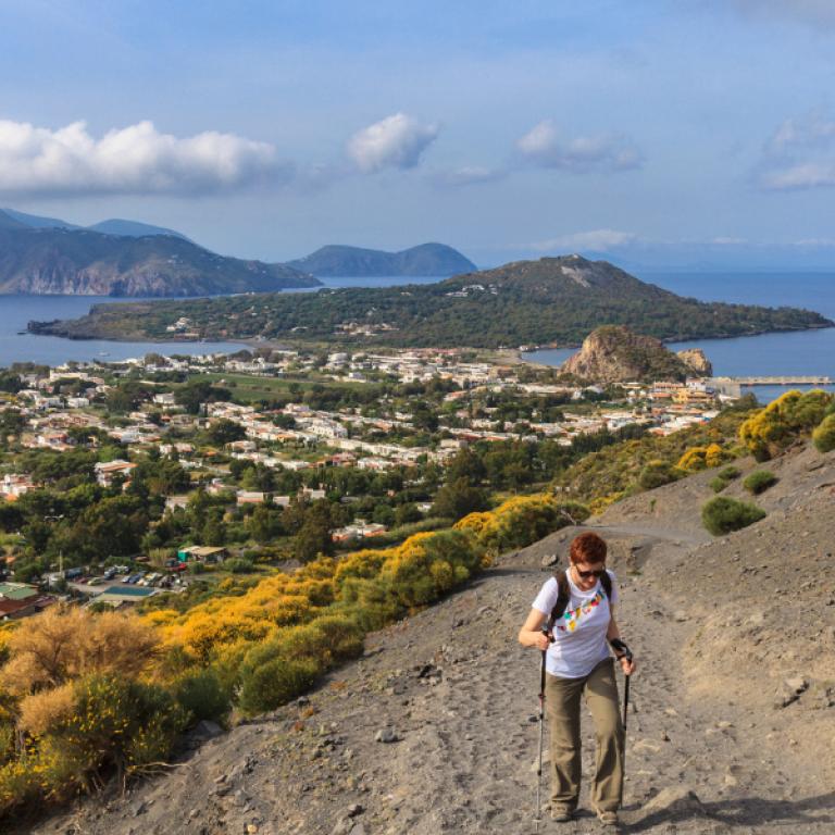 woman climbing a rocky path in Sicily hike