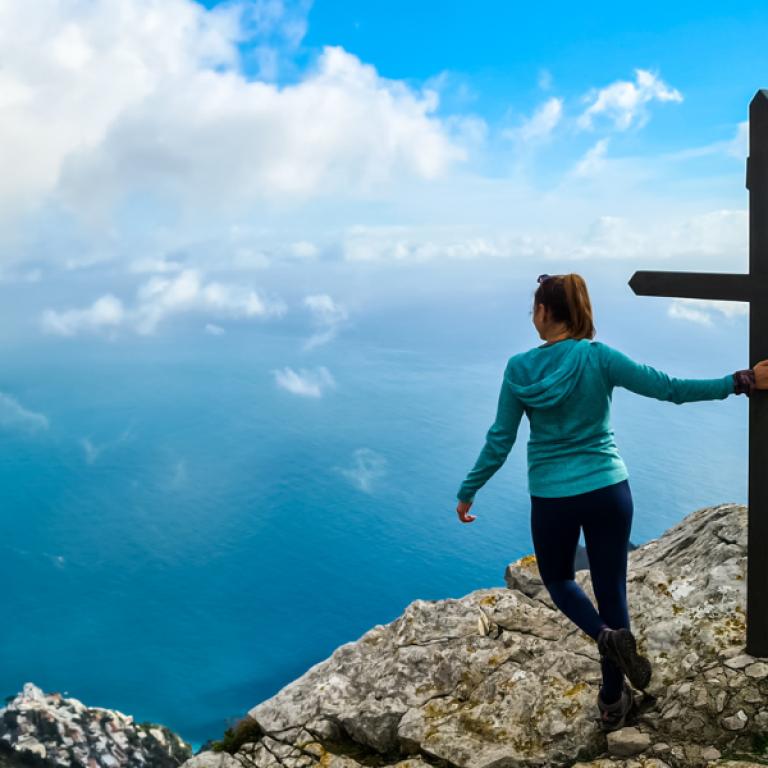 Hikers following a seaside trail overlooking the Mediterranean while hiking in Southern Italy