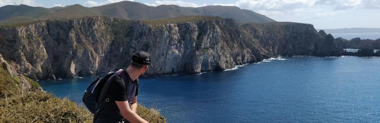 solo trip walker on cliff on sea
