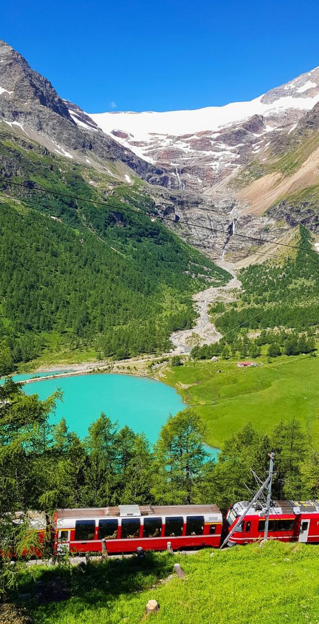 The Red Bernina Express is rolling by the lake