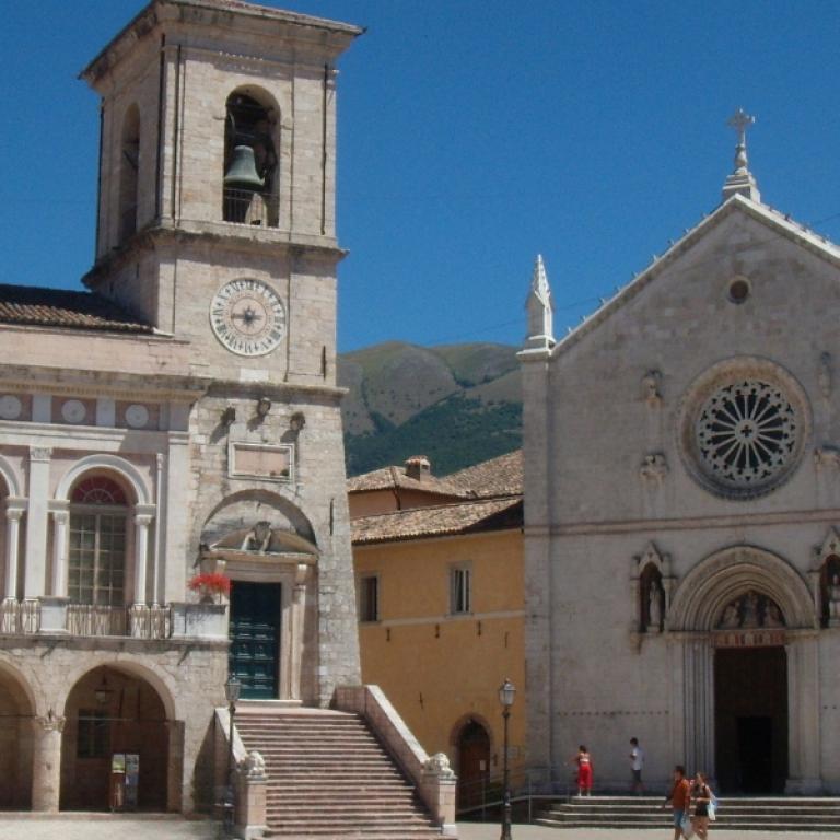 Norcia’s town square surrounded by the Sibillini Mountains, birthplace of Saint Benedict