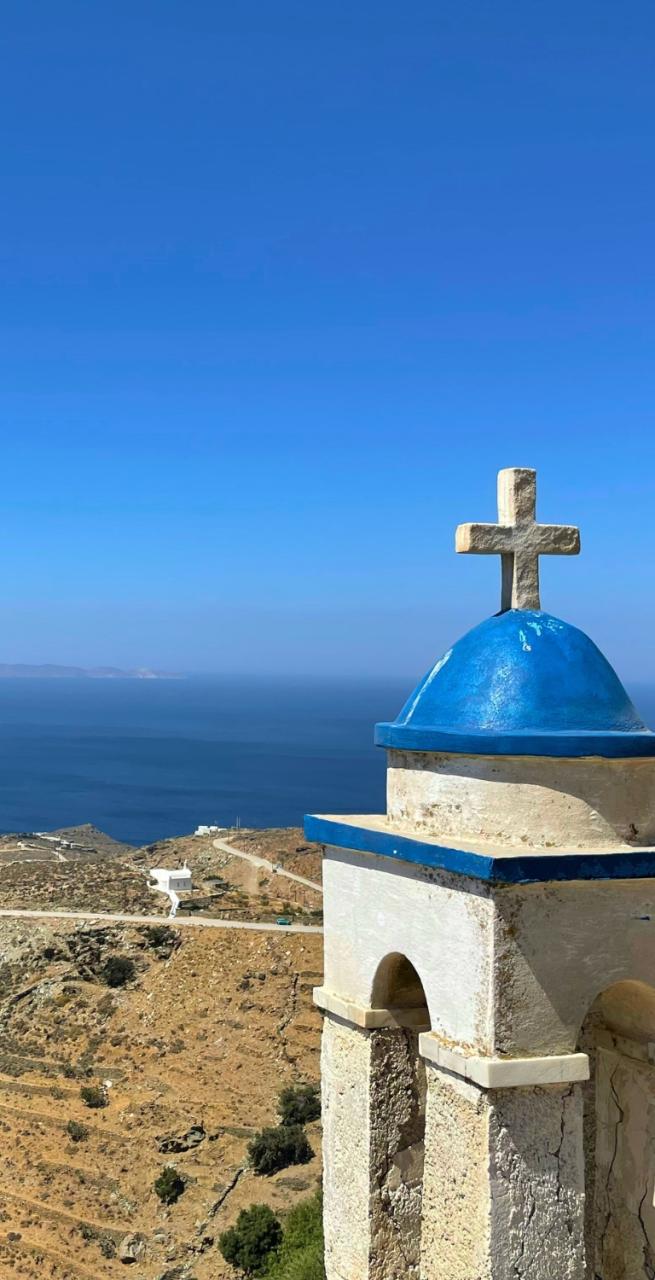 Village of Tinos surrounded by hills and traditional architecture