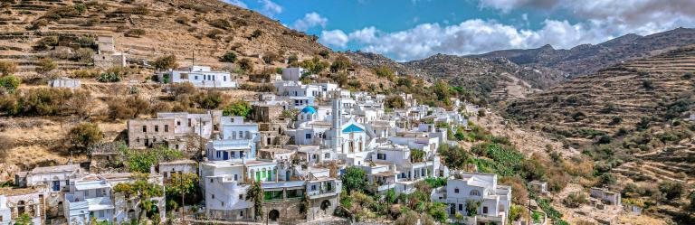 Village of Tinos surrounded by hills and traditional architecture