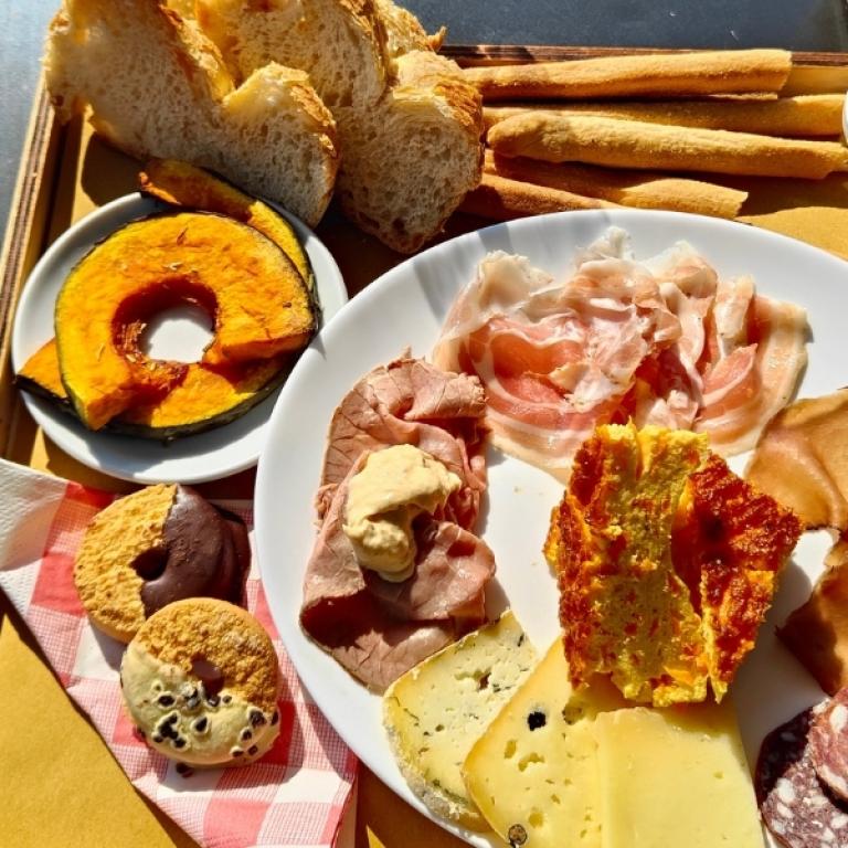 Tasting platter of Piedmont cheeses, cured meats and local products during the Piedmont alpine walking tour