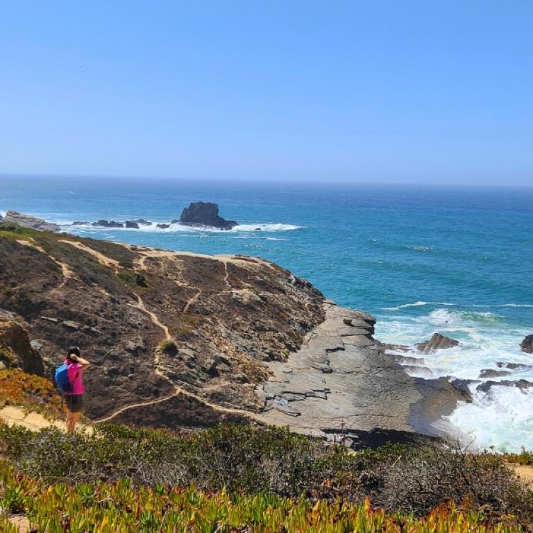 Clifftop path with rocky shoreline and ocean views on the Fisherman’s Trail