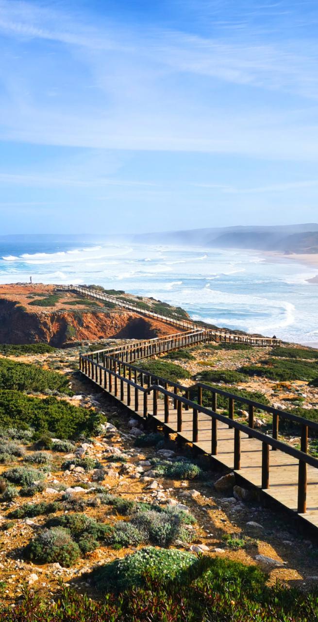 Wooden boardwalk along dramatic coastal cliffs on the Fisherman’s Trail in Portugal